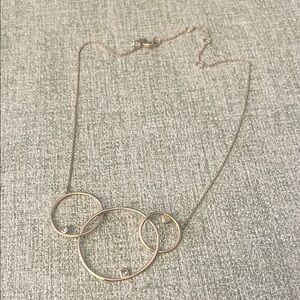 Alexis Bittar Elegant Gold Necklace with Interlocking circles and three stones.